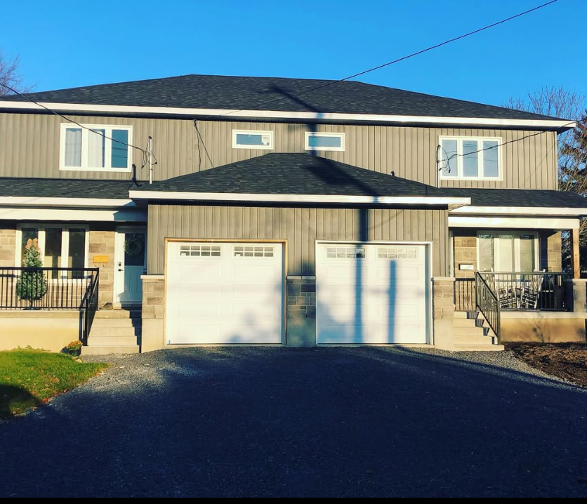 Semi-detached homes with two garages and front porches