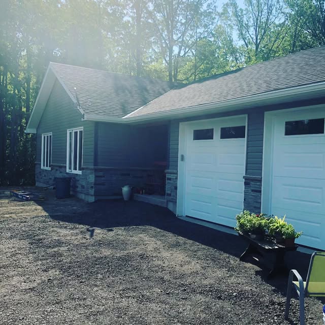Single-storey home among trees with attached double garage
